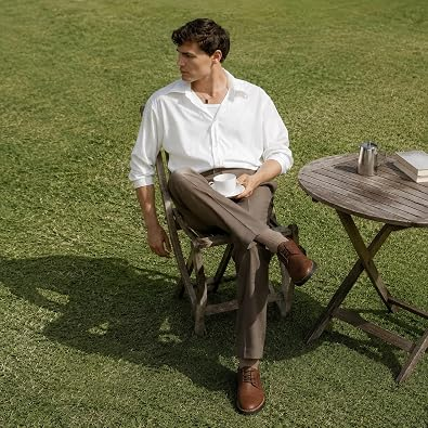 Man sitting outdoors wearing classic brown leather oxford shoes