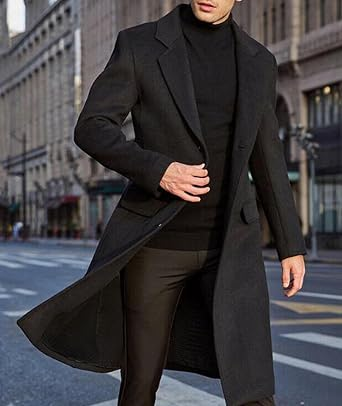 Man wearing a long black trench coat walking through a city street